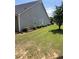 Exterior view of home featuring lush lawn, shrubs, and gray siding at 964 Village View Cir, Loganville, GA 30052
