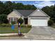 Charming single-story home featuring brick facade, landscaped yard, and a two-car garage at 964 Village View Cir, Loganville, GA 30052