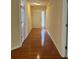 Inviting hallway with hardwood floors and a view of the front door with sidelight windows at 964 Village View Cir, Loganville, GA 30052
