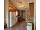 Cozy kitchen with wooden cabinets, white appliances, and a view of the front door at 964 Village View Cir, Loganville, GA 30052