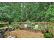 Wooden deck with seating surrounded by a lush backyard, perfect for outdoor entertaining at 1369 Willowbrook Sw Dr, Marietta, GA 30064