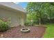 Cozy backyard featuring a fire pit and swing set surrounded by beautiful landscaping, perfect for outdoor relaxation at 1369 Willowbrook Sw Dr, Marietta, GA 30064