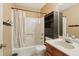 Functional bathroom with a shower-tub combo and cabinet for storage, maximizing space at 1369 Willowbrook Sw Dr, Marietta, GA 30064