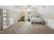 Spacious bedroom under an angled ceiling with an open bookshelf and large comfy bed at 1369 Willowbrook Sw Dr, Marietta, GA 30064