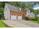 Charming two-story home with a brick facade, two-car garage, and a well-manicured front yard, complemented by lush greenery at 1369 Willowbrook Sw Dr, Marietta, GA 30064