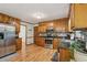 Well-equipped kitchen with stainless steel appliances, granite countertops, and wood cabinets, seamlessly flowing into the dining area at 1369 Willowbrook Sw Dr, Marietta, GA 30064