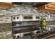 Close up of kitchen stainless steel cooktop with backsplash at 1369 Willowbrook Sw Dr, Marietta, GA 30064