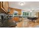 Spacious kitchen featuring granite countertops, stainless steel appliances, wood cabinets, and a view into the adjacent dining area at 1369 Willowbrook Sw Dr, Marietta, GA 30064