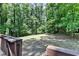 View of a grassy backyard surrounded by mature trees, as seen from the home's deck at 262 Somerset Ct, Lawrenceville, GA 30044