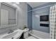 Bathroom features gray tile, white vanity, bathtub, and a shower at 262 Somerset Ct, Lawrenceville, GA 30044