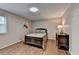 Cozy bedroom features hardwood floors, neutral paint, a decorative painting, and natural light at 262 Somerset Ct, Lawrenceville, GA 30044