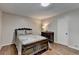 Cozy bedroom with hardwood floors, dark dresser and neutral paint at 262 Somerset Ct, Lawrenceville, GA 30044