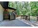 View of a wooden deck with stairs and railing overlooking a natural, wooded backyard at 262 Somerset Ct, Lawrenceville, GA 30044