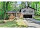 Charming home featuring a brick facade, well-kept lawn, attached garage, and mature trees surrounding the property at 262 Somerset Ct, Lawrenceville, GA 30044