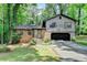 Charming split-level home featuring a brick facade, attached garage, and a lush, wooded lot at 262 Somerset Ct, Lawrenceville, GA 30044