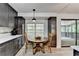 Bright kitchen features a breakfast nook with views to a sunroom, updated countertops, backsplash, and stainless appliances at 262 Somerset Ct, Lawrenceville, GA 30044