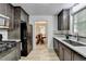 Updated kitchen features a black appliance suite, and updated countertops and backsplash at 262 Somerset Ct, Lawrenceville, GA 30044