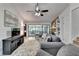 Comfortable living room with brick fireplace, built-in shelving, ceiling fan, and sliding door access to porch at 262 Somerset Ct, Lawrenceville, GA 30044