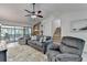 Well-lit living room featuring a brick fireplace, access to the staircase, and sliding doors to the deck at 262 Somerset Ct, Lawrenceville, GA 30044