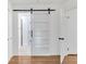 Bathroom features a modern sliding barn door, glass shower door and bright vanity at 2773 Fairlane Dr, Atlanta, GA 30354