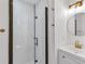 Bathroom with sleek glass shower door, modern vanity, gold hardware and bright lighting at 2773 Fairlane Dr, Atlanta, GA 30354