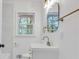 Modern bathroom with white vanity, gold hardware, sleek mirror and updated lighting at 2773 Fairlane Dr, Atlanta, GA 30354