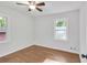 Bright bedroom features hardwood floors, a ceiling fan, and natural light from the windows at 2773 Fairlane Dr, Atlanta, GA 30354