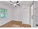 Bright bedroom features hardwood floors, a ceiling fan and sliding barn door at 2773 Fairlane Dr, Atlanta, GA 30354