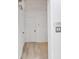Hallway with wooden floors, white walls and doors, and an air conditioning unit above the entrance at 2773 Fairlane Dr, Atlanta, GA 30354