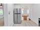 Kitchen showcasing stainless steel refrigerator and open layout into the living area with hardwood floors at 2773 Fairlane Dr, Atlanta, GA 30354