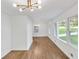 Bright living room featuring fresh paint and hardwood flooring with a view of the dining area at 2773 Fairlane Dr, Atlanta, GA 30354