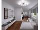 Open-concept living room with hardwood floors, a modern sectional sofa, and a TV perfect for entertaining at 2773 Fairlane Dr, Atlanta, GA 30354