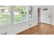 Bright living room featuring fresh paint and hardwood flooring with a view of the front yard at 2773 Fairlane Dr, Atlanta, GA 30354