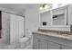 Bathroom with a double sink vanity with a granite countertop and tiled shower and floors at 2912 Palm Dr, East Point, GA 30344