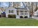 Charming home featuring a well-maintained front yard, a covered porch, and beautiful landscaping at 2912 Palm Dr, East Point, GA 30344