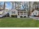 Charming home featuring a well-maintained front yard, a covered porch, and beautiful landscaping at 2912 Palm Dr, East Point, GA 30344