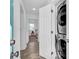 Hallway with laundry unit and view into bedroom at 2912 Palm Dr, East Point, GA 30344