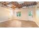 Unfinished basement with natural light, laminate floors, offering customizable space and potential at 404 Summerchase Way, Woodstock, GA 30189