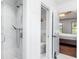 Bright bathroom featuring a tile shower with glass door and toilet with clever storage at 404 Summerchase Way, Woodstock, GA 30189