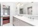 Bright bathroom featuring double sinks, storage, and shiplap with a view to a bedroom at 404 Summerchase Way, Woodstock, GA 30189