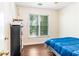 Bedroom featuring hardwood floors, a large window, and neutral paint at 404 Summerchase Way, Woodstock, GA 30189