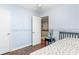 This bedroom has hardwood floors and neutral walls and a view to the staircase at 404 Summerchase Way, Woodstock, GA 30189
