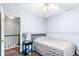 This bedroom has hardwood floors, a ceiling fan, and a view to the staircase at 404 Summerchase Way, Woodstock, GA 30189