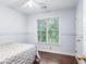 Cozy bedroom with a ceiling fan, a large window, and hardwood floors at 404 Summerchase Way, Woodstock, GA 30189