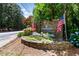 Stone entrance sign 'Summerchase' adorned with American flags and colorful landscaping at 404 Summerchase Way, Woodstock, GA 30189