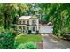 Charming two-story home with a well-manicured front yard and a two-car garage, surrounded by lush greenery at 404 Summerchase Way, Woodstock, GA 30189