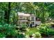 Charming two-story home with inviting porch and well-kept lawn nestled among lush, mature trees at 404 Summerchase Way, Woodstock, GA 30189