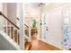 Bright Foyer with wood stairs, hardwood floors, and decorative glass in the sidelights of the front door at 404 Summerchase Way, Woodstock, GA 30189