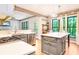 Bright eat-in kitchen with stainless appliances, grey cabinets, and large island featuring pendant lighting at 404 Summerchase Way, Woodstock, GA 30189