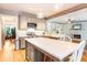 Open eat-in kitchen with stainless appliances, grey cabinets, island and sightlines into the living room at 404 Summerchase Way, Woodstock, GA 30189